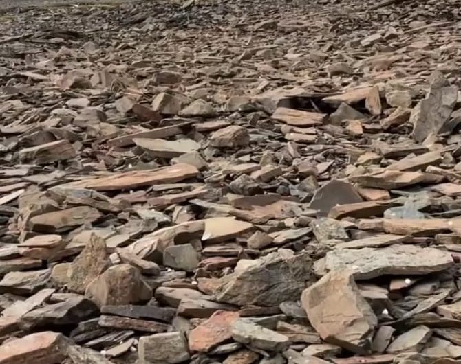 The sound of hail falling on a mountainside covered with slate rocks