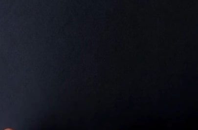 The way chalk and pastels are smudged on black paper to create light rays above a bench