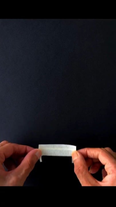 The way chalk and pastels are smudged on black paper to create light rays above a bench