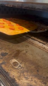 The way he tops the pizza with pepperoni after it's already in the oven