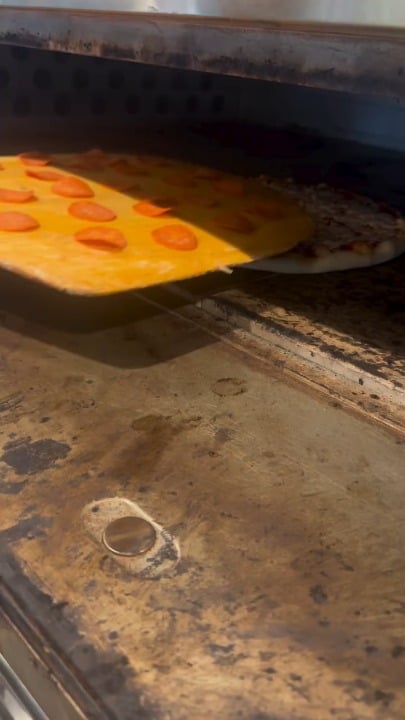 The way he tops the pizza with pepperoni after it's already in the oven