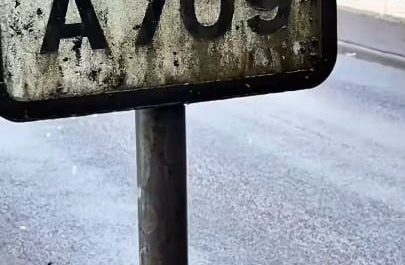 The way this water-fed brush cleans thick dirt off road signs