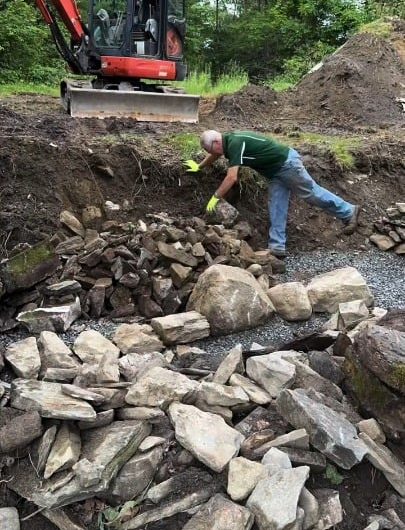 This guy builds a dry lay, fieldstone/flagstone retaining wall with steps