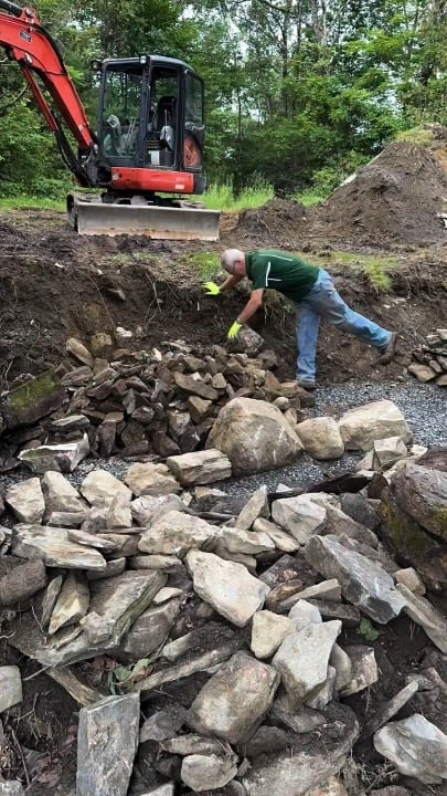 This guy builds a dry lay, fieldstone/flagstone retaining wall with steps