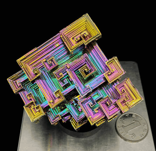 This is a Bismuth hopper crystal. Its bizarre, maze-like stair-step structure happens entirely naturally because the outer edges grow much faster than the interior.