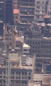 Two climbers have scaled the Empire State Building and unfurled a banner from the top of the spire