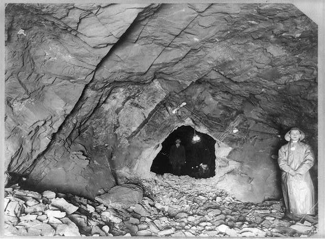 Two workers standing where the Catskill Aqueduct tunnels met 1,100 feet under the Hudson River 1912