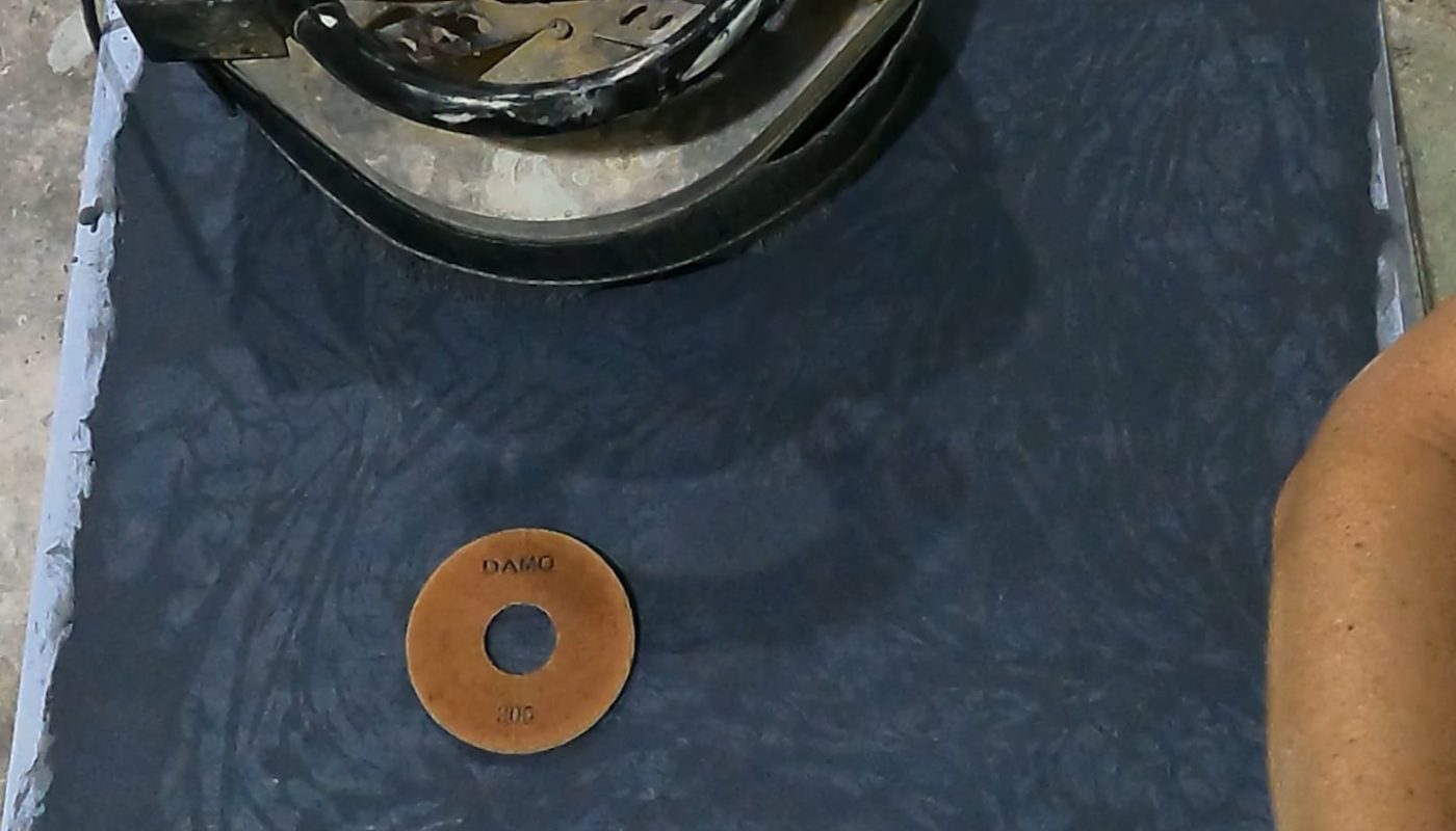 Wet grinding a concrete table top to expose and polish an intricate inlay - OC