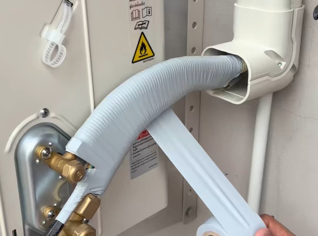 Wrapping up tape around air conditioner pipes