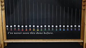 A mercury pendulum wave: 20 little bottles containing slightly different masses of mercury so the oscillating frequency is slightly different