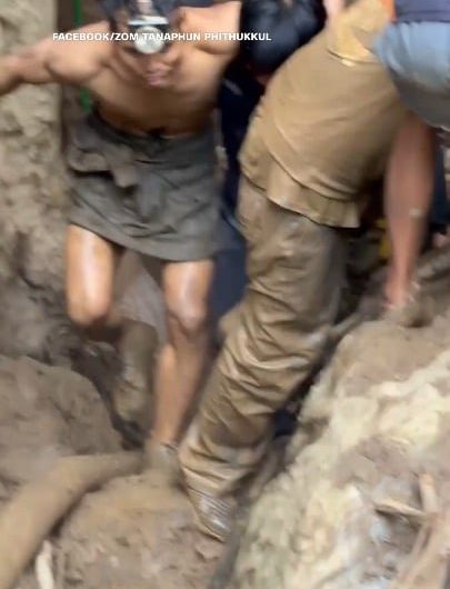 After spending over a week trapped in a flooded cave, four Lao villagers stunned rescuers by emerging on their own. Videos show them crawling and walking to safety moments before rescue teams were set to enter the cave.