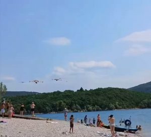 Astonished beachgoers at the Lac de Sainte Croix film five French Canadair CL-415 firefighting planes scooping up water in quick succession to fight the wildfires in southern France.