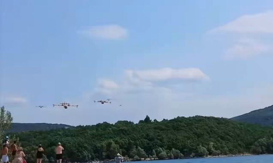 Astonished beachgoers at the Lac de Sainte Croix film five French Canadair CL-415 firefighting planes scooping up water in quick succession to fight the wildfires in southern France.