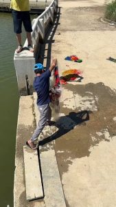 Net fishing at river bank