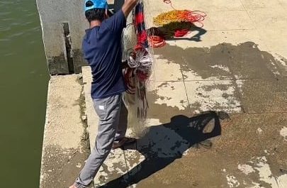 Net fishing at river bank