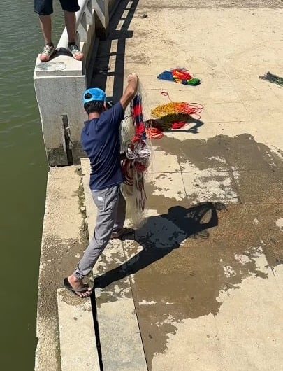 Net fishing at river bank