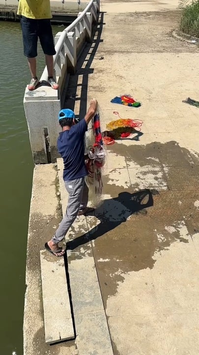 Net fishing at river bank