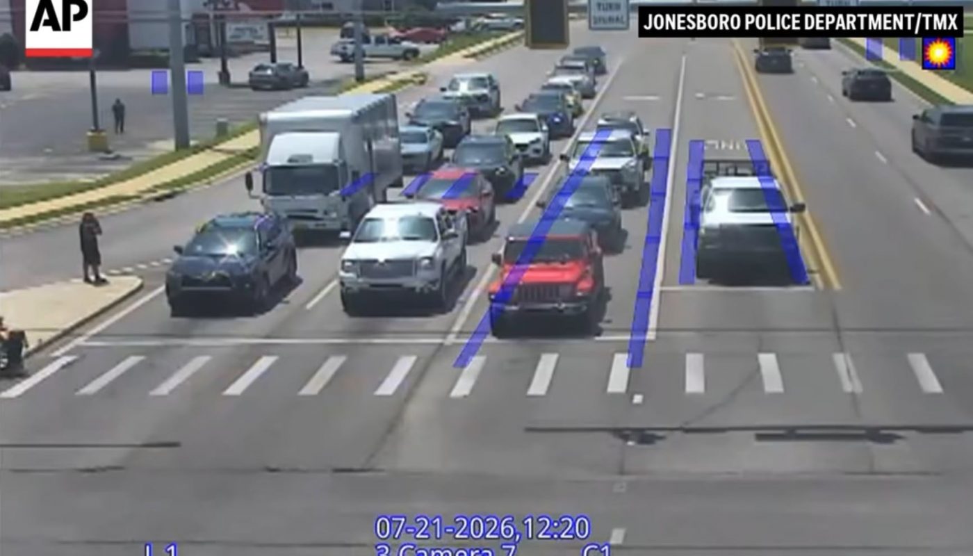 Spider-Man helps a man in a wheelchair cross the street